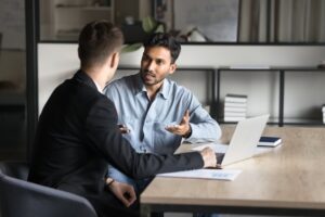 Two people discussing in office.