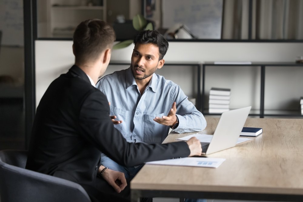 Two people discussing in office.