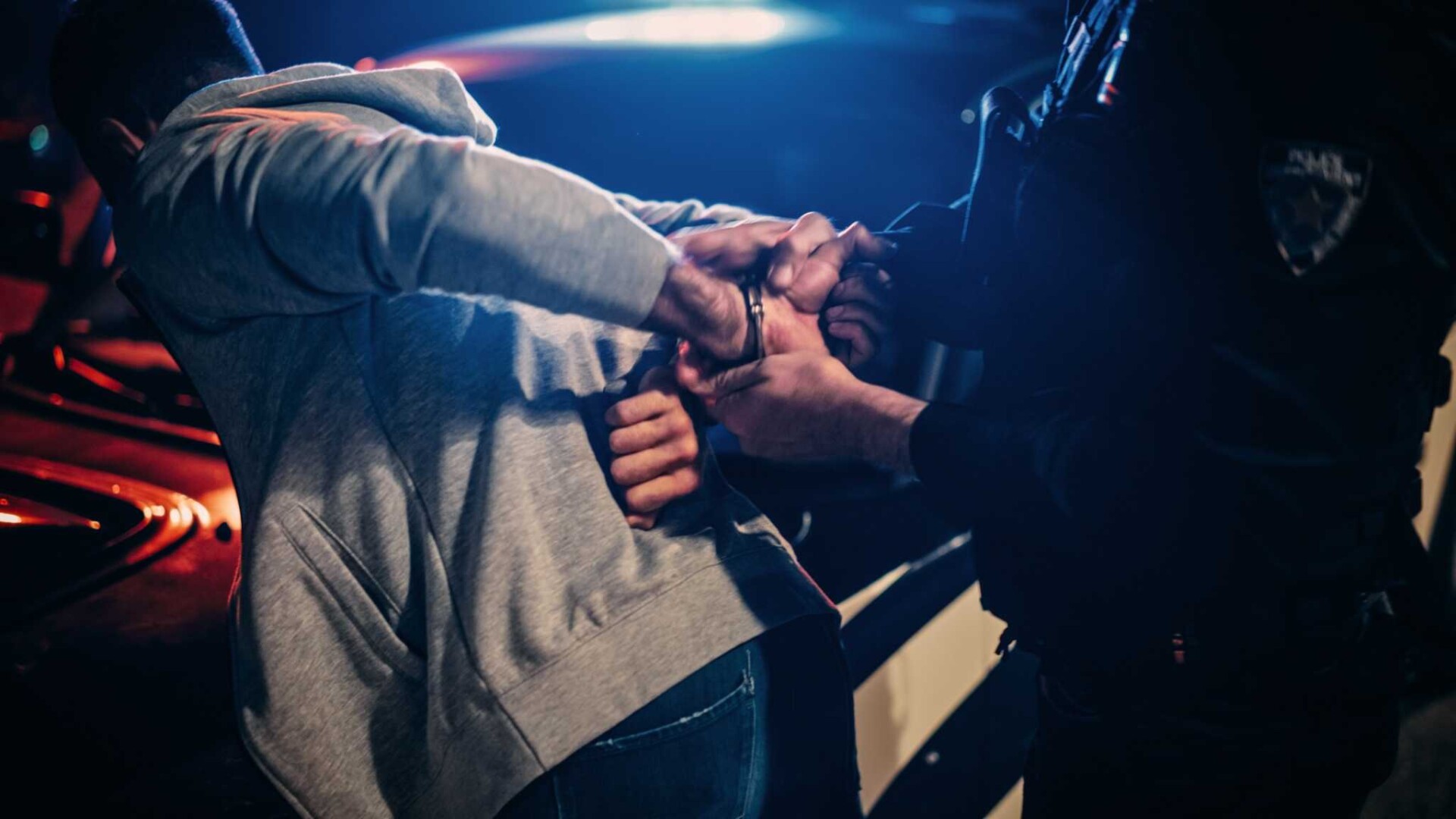 Person being handcuffed by police officer during arrest