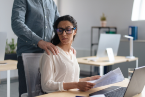 A woman feeling threatened by her coworker’s touching