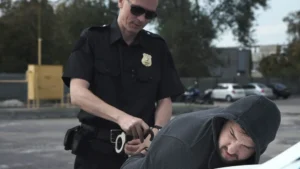 Police officer is arresting a criminal and reading Miranda rights to him