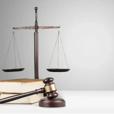 shutterstock_432179479 A gavel and scales of justice on legal books.