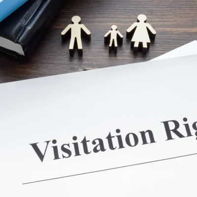 shutterstock_2455569895 Visitation rights documents, books and family figures.